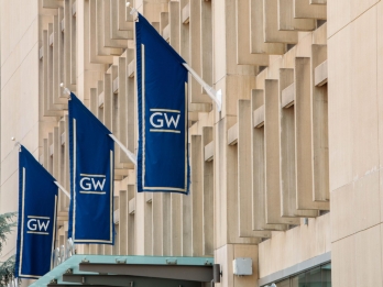 A row of three vertical, dark blue banners with the 